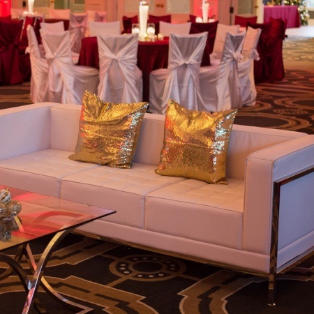 White Tufted Sofa and Gold Sequin Pillows