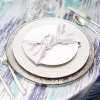 Platinum Orizzonte Glass Charger, and Silver Matte Satin Napkin