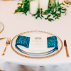White Economy and Teal Iridescent Crush Linen Rentals with Glass Gold Beaded Charger